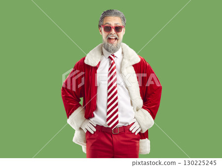Cheerful bearded man Santa Claus wearing stylish red sunglasses and costume 130225245