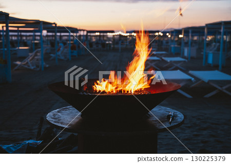 Beach Bonfire at Sunset with Glowing Flames Beach Bonfire at Sunset with Glowing Flames 130225379