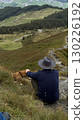 Man and Dog Relaxing on Mountain Overlooking Valley 130226192