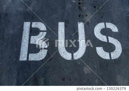 A clearly marked bus parking space is visible on a city street, emphasizing the importance of designated transit areas for public transport A clearly marked bus parking space is visible on a city street, emphasizing the importance of designated transit areas for public transport 130226379