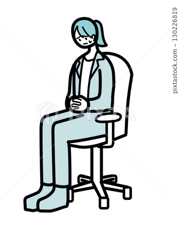 A female office worker sitting in a chair with her hands folded on her stomach 130226819