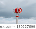 Emergency tsunami warning siren standing under a cloudy sky 130227699