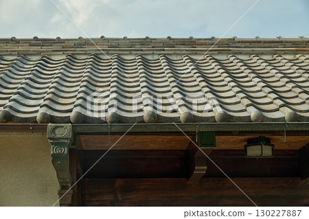 Background material of traditional Japanese architecture. Roof tiles and rain gutters that have turned a deep green with verdigris. 130227887