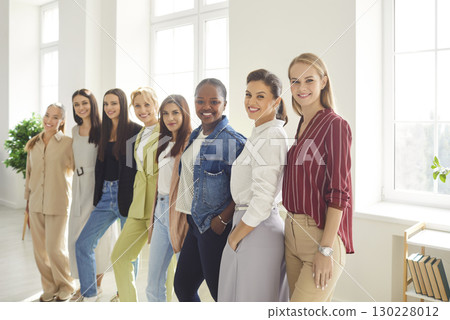 Portrait of confident women group looking cheerful at camera and smiling standing in a row Portrait of confident women group looking cheerful at camera and smiling standing in a row 130228012