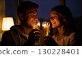 Romantic couple celebrating with champagne flutes at night 130228401