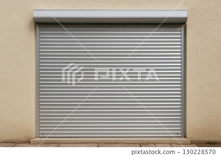 Closed Metallic Security Shutter on Beige Wall 130228570