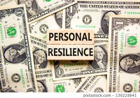 Personal resilience symbol. Concept word Personal resilience on wooden blocks. Beautiful background from dollar bills. Business psychological personal resilience concept. Copy space. Personal resilience symbol. Concept word Personal resilience on wooden blocks. Beautiful background from dollar bills. Business psychological personal resilience concept. Copy space. 130228641