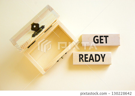 Get ready symbol. Concept words Get ready on wooden blocks on a beautiful white table white background. Empty wooden chest. Business, support, motivation and get ready concept. Copy space. 130228642