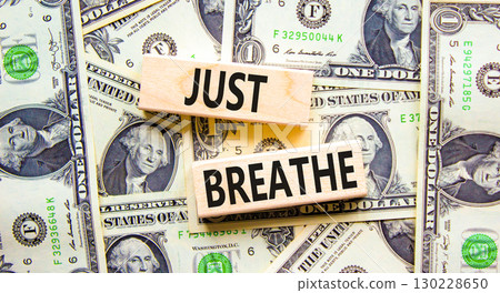 Just breathe and psychological symbol. Concept words Just breathe on beautiful wooden block. Beautiful background from dollar bills. Business psychological and Just breathe concept. Copy space 130228650