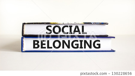 Social belonging symbol. Books with concept words Social belonging on beautiful white background. Business political social belonging concept. Copy space. 130228656