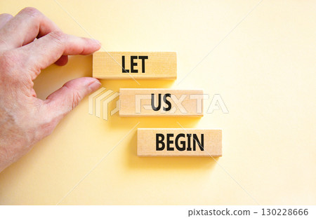 Let us begin symbol. Concept words Let us begin on beautiful wooden blocks. Beautiful white background. Businessman hand. Business motivational let us begin concept. Copy space. Let us begin symbol. Concept words Let us begin on beautiful wooden blocks. Beautiful white background. Businessman hand. Business motivational let us begin concept. Copy space. 130228666