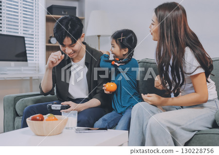 Family spends their free time together Family spends their free time together 130228756