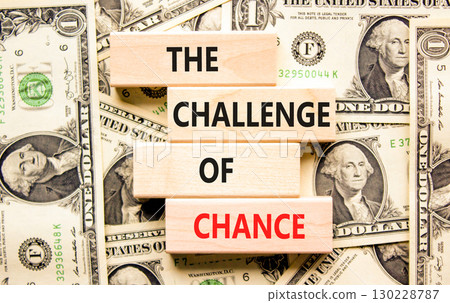 The challenge of chance symbol. Concept words phrase The challenge of chance on beautiful blocks. Dollar bills. Beautiful dollar bills background. Business The challenge of chance concept. Copy space. The challenge of chance symbol. Concept words phrase The challenge of chance on beautiful blocks. Dollar bills. Beautiful dollar bills background. Business The challenge of chance concept. Copy space. 130228787