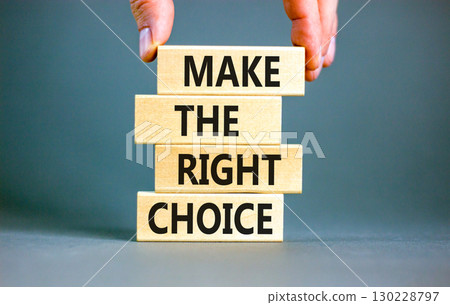 Make the right choice symbol. Concept words phrase Make the right choice on beautiful wooden blocks. Beautiful grey background. Businessman's hand. Business Make the right choice concept. Copy space. Make the right choice symbol. Concept words phrase Make the right choice on beautiful wooden blocks. Beautiful grey background. Businessman's hand. Business Make the right choice concept. Copy space. 130228797