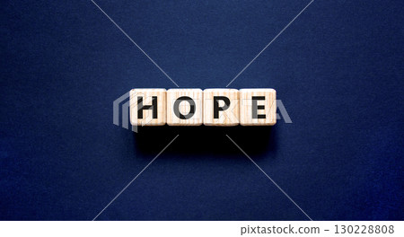 Hope symbol. Concept word Hope on beautiful wooden blocks. Beautiful black table black background. Business, lifestyle, support and hope concept. Copy space. 130228808