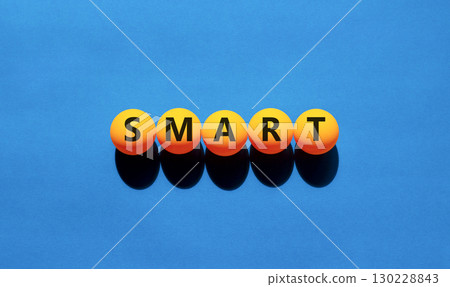 Smart symbol. Concept word Smart on beautiful yellow tennis ping pong balls. Beautiful wooden table wooden background. Business lifestyle smart concept. Copy space. 130228843
