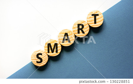 Smart symbol. Concept word Smart on beautiful wooden circles. Beautiful white and blue background. Business lifestyle smart concept. Copy space. 130228851