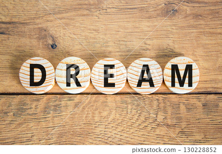 Dream symbol. Concept word Dream on beautiful wooden circles. Beautiful wooden table wooden background. Business lifestyle dream concept. Copy space. 130228852