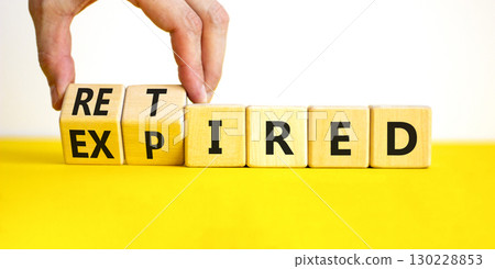 Retired or expired symbol. Concept words Retired Expired on wooden cubes. Beautiful yellow table white background. Businessman hand. Business and retired or expired concept. Copy space. 130228853