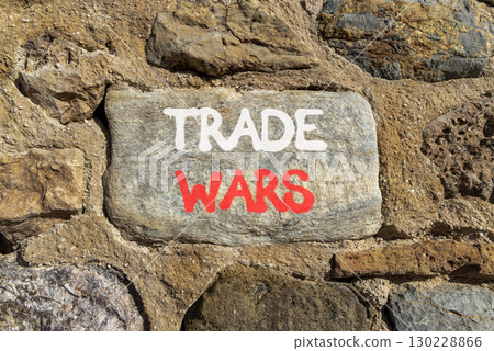 Trade wars symbol. Concept word Trade wars on beautiful grey stone on stone wall. Beautiful stone wall background. Business trade wars concept. Copy space. 130228866