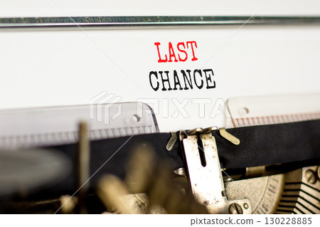 Last chance symbol. Concept word Last chance typed on beautiful old retro typewriter. Beautiful white paper background. Business last chance concept. Copy space. Last chance symbol. Concept word Last chance typed on beautiful old retro typewriter. Beautiful white paper background. Business last chance concept. Copy space. 130228885