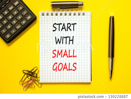 Start with small goals symbol. Concept words phrase Start with small goals on beautiful note. Black pen. Calculator. Beautiful yellow background. Business Start with small goals concept. Copy space Start with small goals symbol. Concept words phrase Start with small goals on beautiful note. Black pen. Calculator. Beautiful yellow background. Business Start with small goals concept. Copy space 130228887