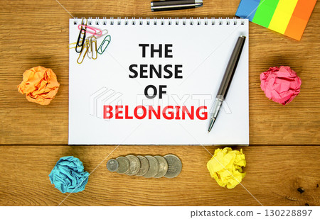 The sense of belonging symbol. Concept words The sense of belonging on beautiful white note. Beautiful wooden background. Black pen. Business and the sense of belonging concept. Copy space. 130228897