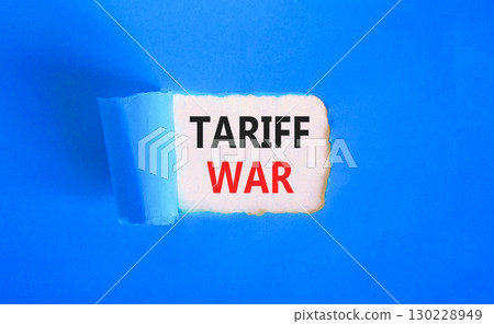 Trade tariff war symbol. Concept word Tariff war on beautiful white paper. Beautiful blue paper background. Business trade tariff wars concept. Copy space. 130228949