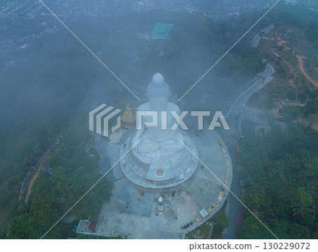aerial view Mist blows over the Phuket Big Buddha in sweet sunrise 130229072