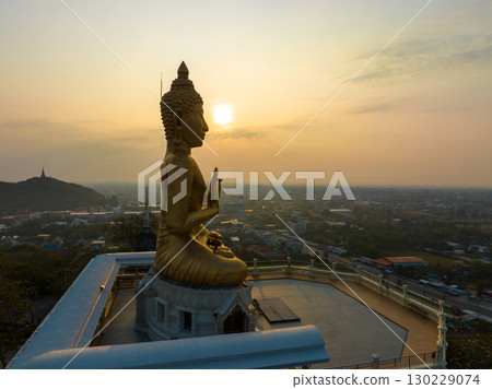 aerial view scenery sky in sunrise above the golden big buddha. aerial view scenery sky in sunrise above the golden big buddha. 130229074