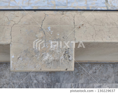 Close up of a weathered stone ledge showing cracks and natural discoloration patterns Close up of a weathered stone ledge showing cracks and natural discoloration patterns 130229637