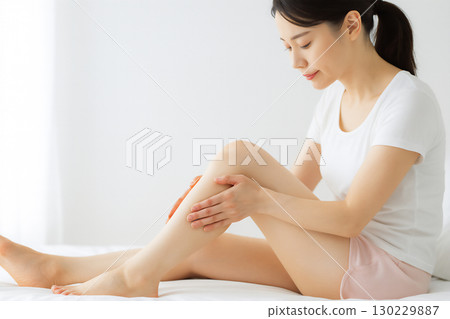 Japanese woman giving leg massage 130229887