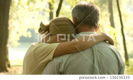 Loving Father Embracing Grown Daughter in Peaceful Natural Setting Loving Father Embracing Grown Daughter in Peaceful Natural Setting 130230135