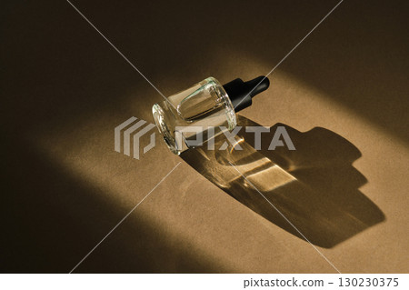 Natural facial serum with beautiful highlights on a beige background. Natural facial serum with beautiful highlights on a beige background. 130230375