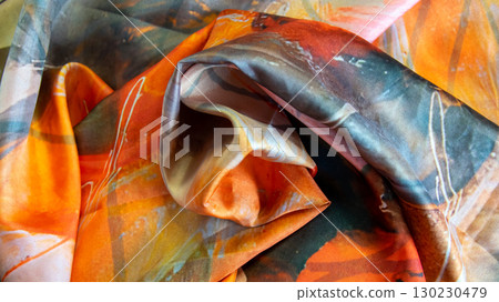 Textile silk scarf. Yellow, orange, brown handmade texture fabric. Cloth background. Textile silk scarf. Yellow, orange, brown handmade texture fabric. Cloth background. 130230479