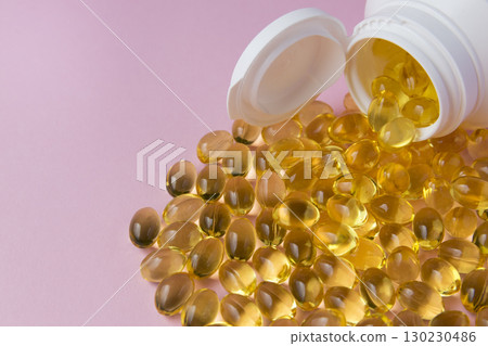Vitaminen Omega 3 oil in capsules on pink background. Much medical pills in white plastic bottle. Healthcare concept. Vitaminen Omega 3 oil in capsules on pink background. Much medical pills in white plastic bottle. Healthcare concept. 130230486