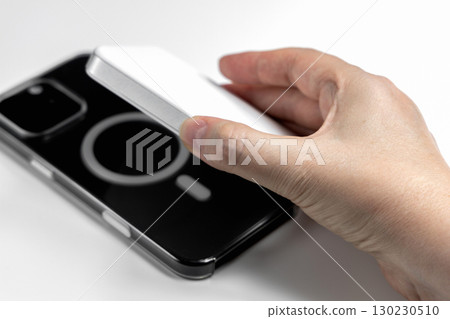 Hand holding phone and external magnetic battery Hand holding phone and external magnetic battery 130230510