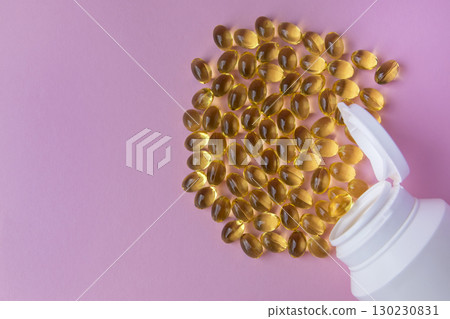 Vitaminen Omega 3 oil in capsules on the pink background. Much medical pills and drugs in white plastic bottle. Healthcare concept. 130230831