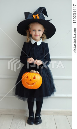 Little girl dressed as a witch for Halloween party 130231447