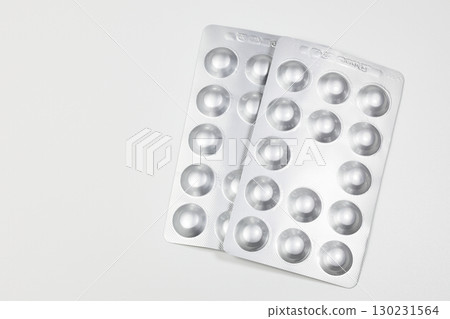 Medical drugs and pills in silver shiny package isolated on white background. Medical drugs and pills in silver shiny package isolated on white background. 130231564
