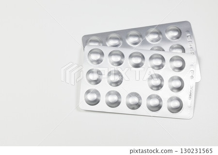 Medical drugs and pills in silver shiny package isolated on white background. 130231565