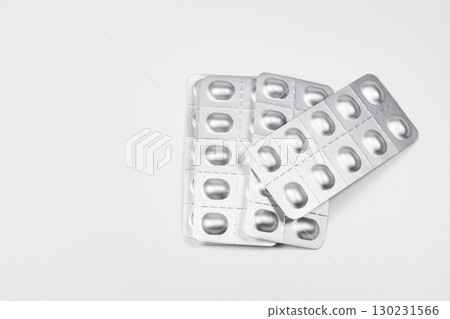 Medical drugs and pills in silver shiny package isolated on white background. 130231566