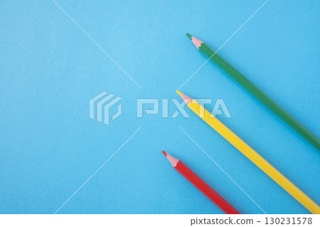 Three pencils red, yellow, green on the bright blue background. Traffic light colors. Close up. Design concept. Space for text. Three pencils red, yellow, green on the bright blue background. Traffic light colors. Close up. Design concept. Space for text. 130231578
