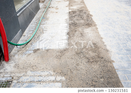 Road renovation repair in big city. Construcion site of pavement cobbleston street. Roadworks stonework at pedestrian area. Urban development 130231581