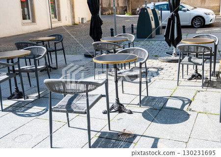 Cafe on the open air. Chairs and tables outside with summer sun weather in France on the street. Design of furnitureset for summer cafe or restaurant. Cafe on the open air. Chairs and tables outside with summer sun weather in France on the street. Design of furnitureset for summer cafe or restaurant. 130231695