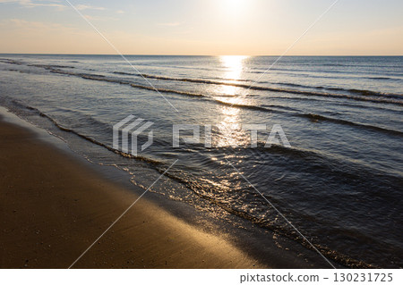Beautiful beach and sea illuminated by the setting sun 130231725