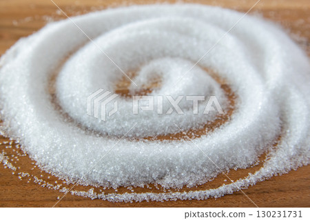 White granulated sugar for cooking food on the natural wood background. White granulated sugar for cooking food on the natural wood background. 130231731