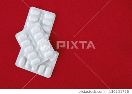 Much medical pills and drugs in white package on a red background. Healthcare concept. Space for text. 130231736