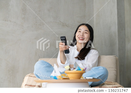 Adult woman enjoying TV on the sofa 130231747
