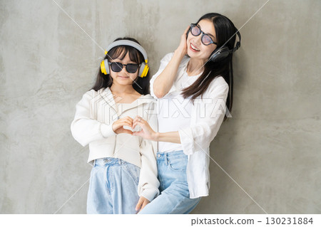 A close parent and child enjoying dancing while listening to music A close parent and child enjoying dancing while listening to music 130231884